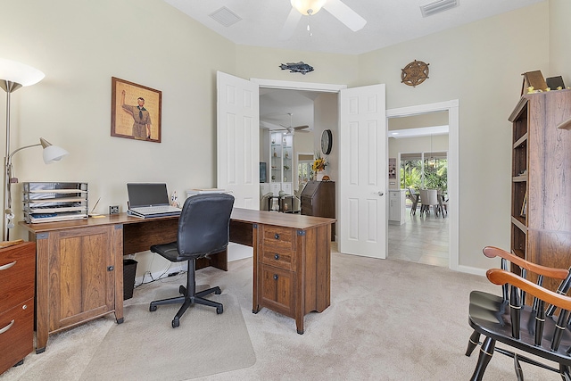 carpeted office space featuring ceiling fan