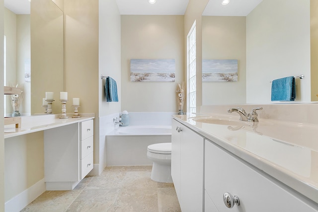 bathroom featuring vanity, toilet, and a washtub