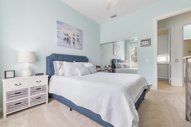 carpeted bedroom featuring ceiling fan and a closet