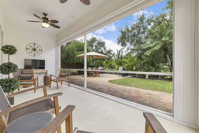 sunroom featuring ceiling fan