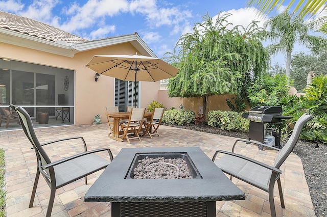 view of patio featuring grilling area and a fire pit