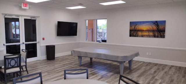 rec room with hardwood / wood-style floors, a paneled ceiling, and pool table