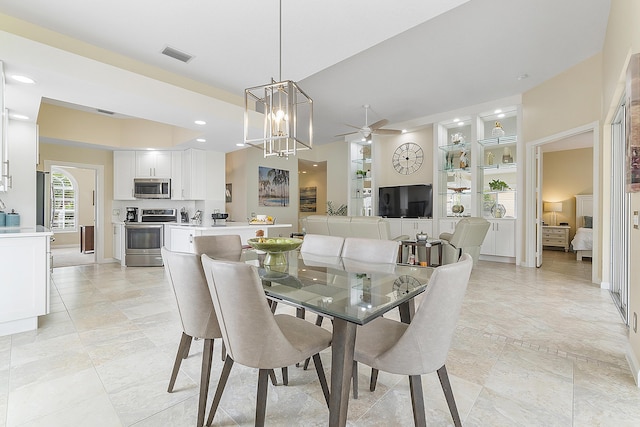 dining area featuring ceiling fan with notable chandelier