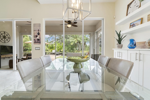 dining room featuring ceiling fan with notable chandelier