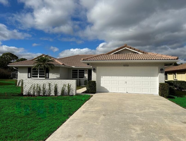 view of front of house with a garage and a front lawn