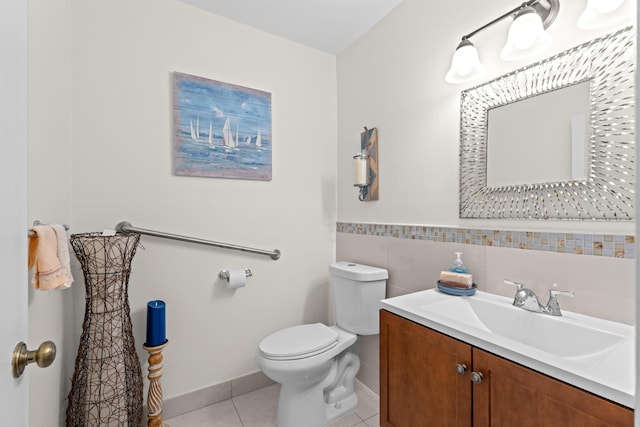 bathroom with tile patterned flooring, vanity, and toilet