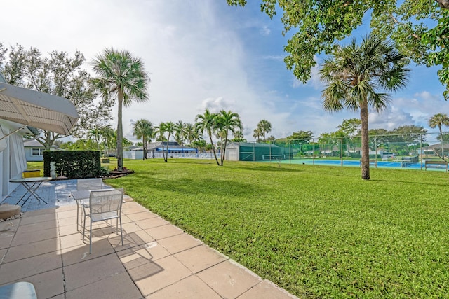 view of yard featuring tennis court and a water view