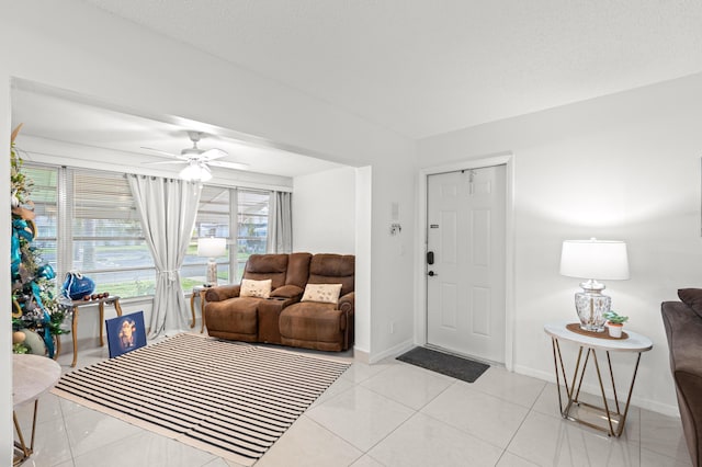 tiled entrance foyer with ceiling fan