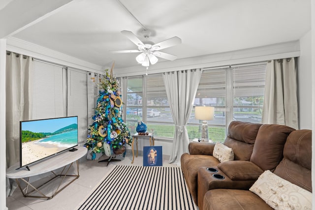 tiled living room featuring ceiling fan and crown molding