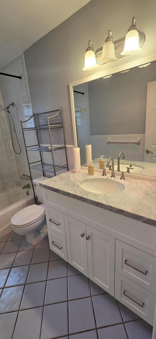 full bathroom featuring tile patterned floors, vanity, toilet, and tiled shower / bath