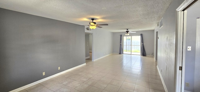 tiled spare room featuring ceiling fan and a textured ceiling