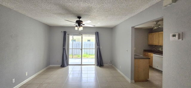 interior space with ceiling fan, light tile patterned flooring, and a textured ceiling