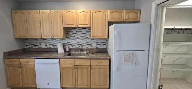 kitchen with sink, light brown cabinets, tasteful backsplash, white appliances, and light tile patterned floors