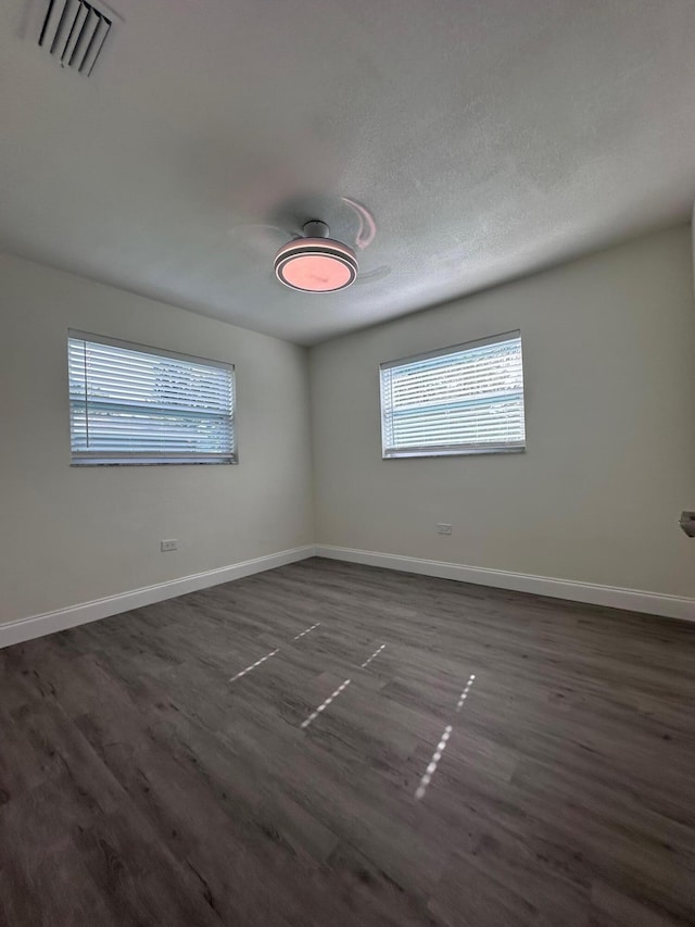 spare room with dark wood-type flooring