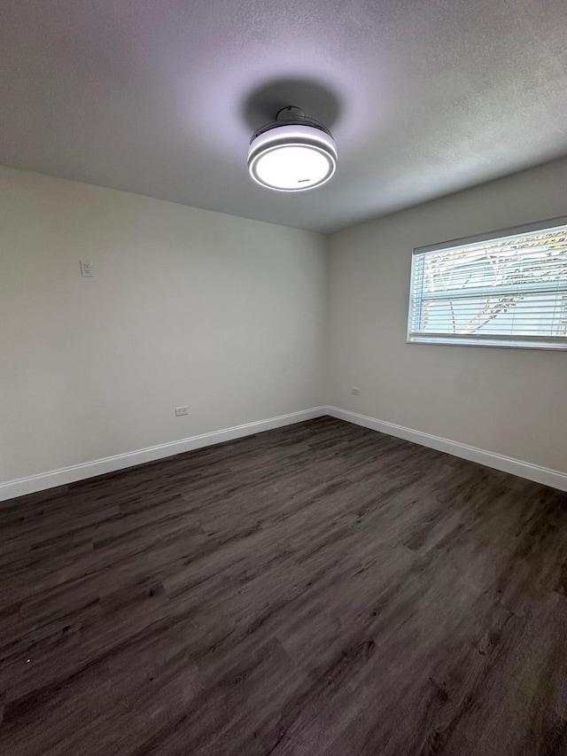 empty room featuring dark wood-type flooring