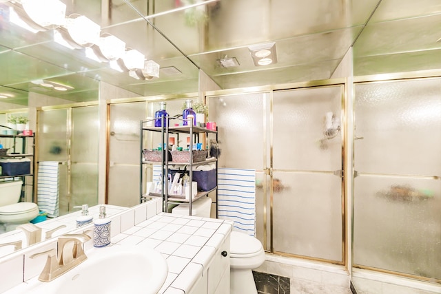 bathroom featuring vanity, an enclosed shower, and toilet