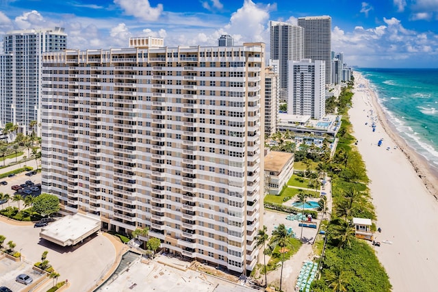 view of building exterior featuring a view of the beach and a water view