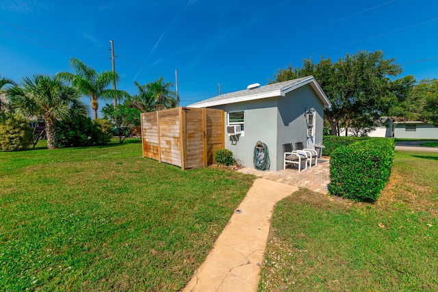 exterior space with a yard and cooling unit