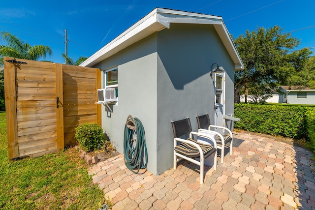 view of property exterior featuring a patio area and cooling unit