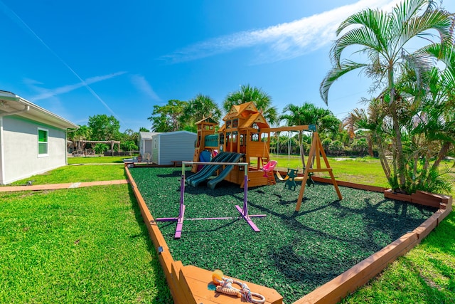 view of playground featuring a yard and a storage unit