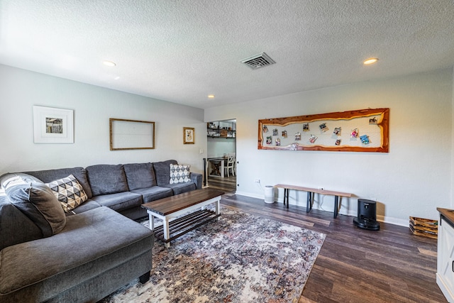 living room with dark hardwood / wood-style floors and a textured ceiling