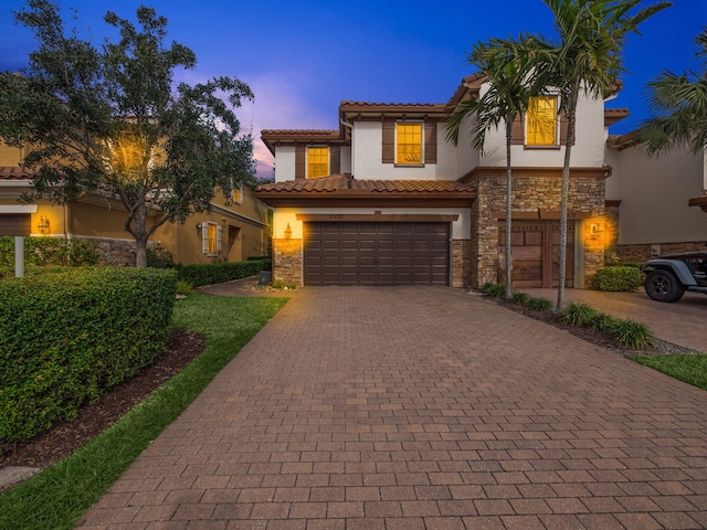 mediterranean / spanish-style home featuring a garage