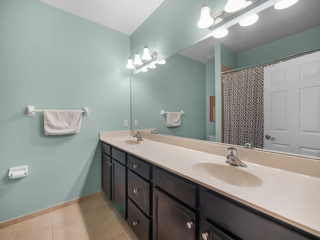 bathroom featuring a shower with curtain, tile patterned flooring, and vanity