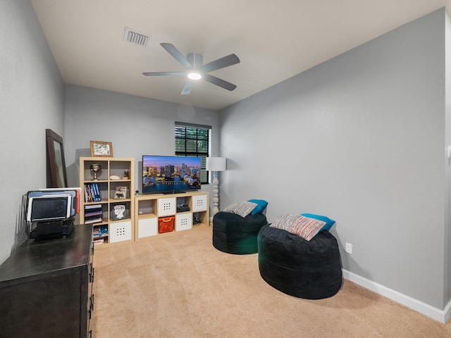 living area featuring ceiling fan and carpet floors