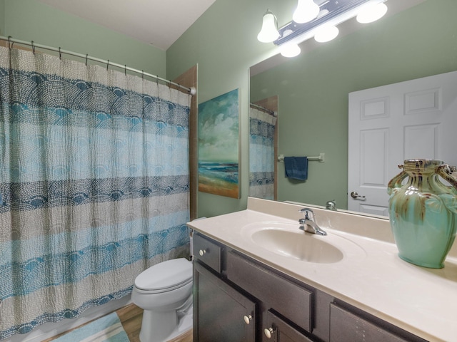 full bathroom featuring hardwood / wood-style flooring, vanity, toilet, and shower / bath combo with shower curtain