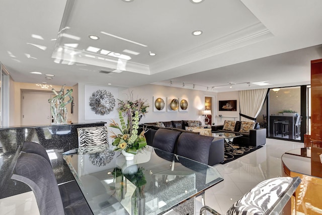 tiled dining room with a tray ceiling and ornamental molding