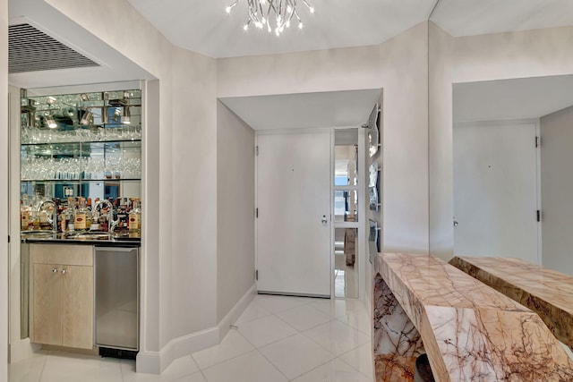 entrance foyer featuring light tile patterned floors and bar area