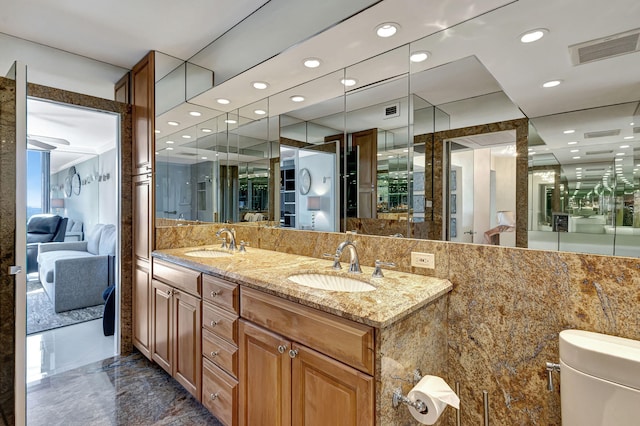 bathroom featuring vanity and toilet