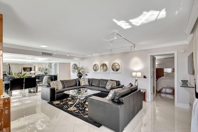 living room featuring rail lighting, light tile patterned flooring, and ornamental molding