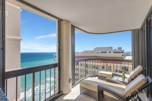 balcony with a water view and a beach view