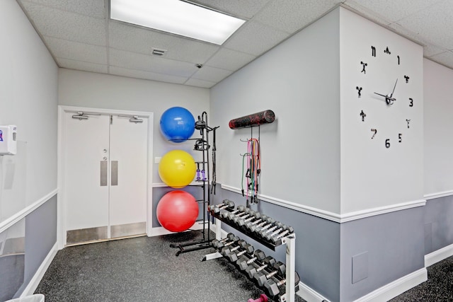 workout area featuring a paneled ceiling