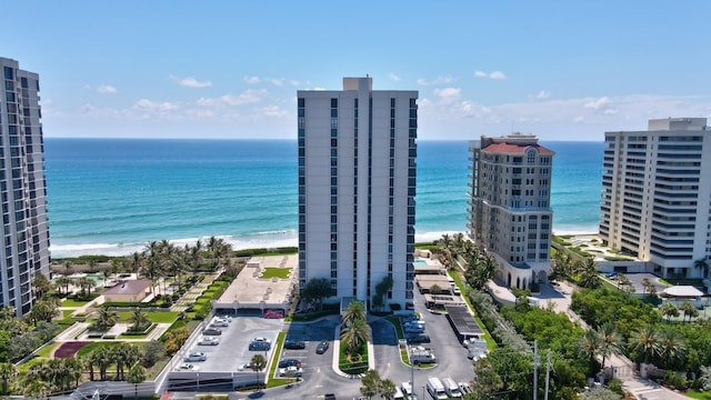 drone / aerial view featuring a water view and a beach view