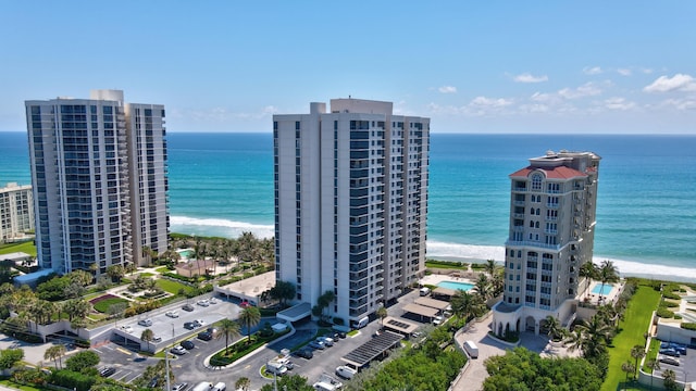 birds eye view of property with a water view and a beach view