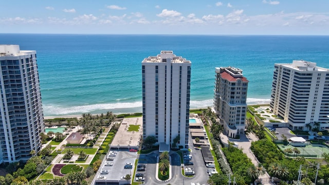 drone / aerial view featuring a water view and a beach view