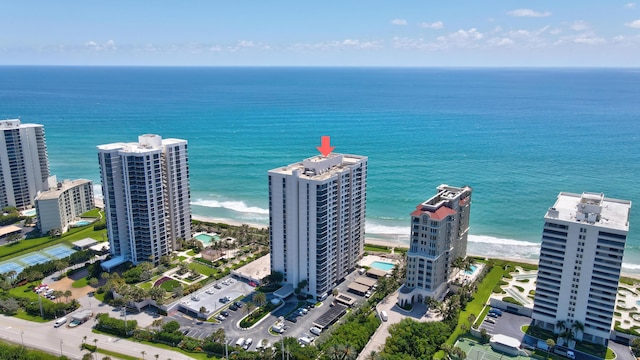 drone / aerial view featuring a water view and a view of the beach