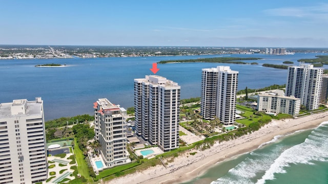 bird's eye view with a water view and a view of the beach