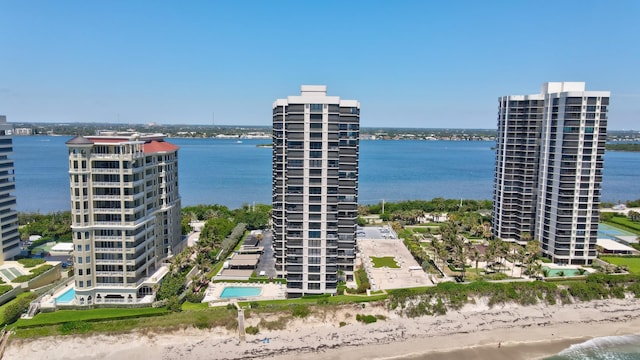 bird's eye view with a water view and a beach view