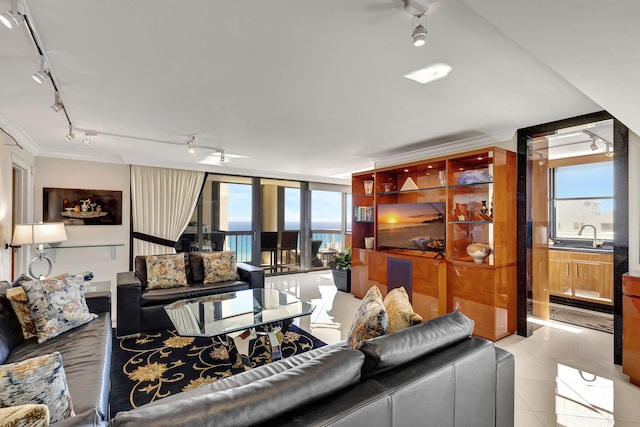 living room featuring light tile patterned floors, floor to ceiling windows, and sink