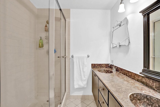 bathroom featuring tile patterned flooring, vanity, and walk in shower