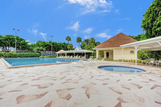 view of swimming pool with an in ground hot tub and a patio