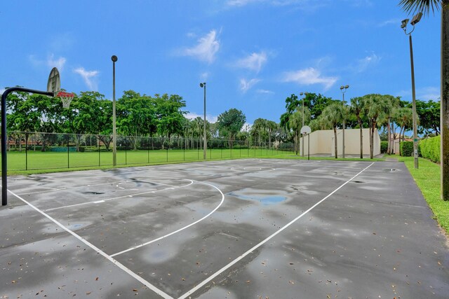 view of sport court featuring a lawn