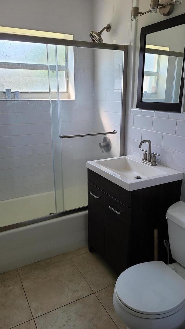 full bathroom with toilet, vanity, and tile patterned floors