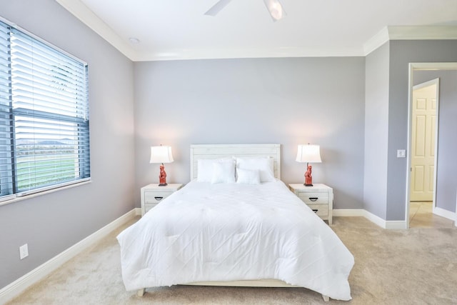 carpeted bedroom featuring ornamental molding and ceiling fan