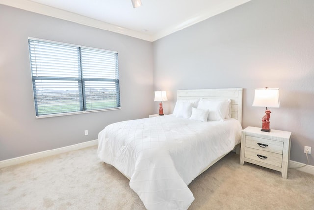 bedroom with baseboards, light colored carpet, and ornamental molding