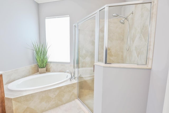 bathroom featuring a bath and a shower stall