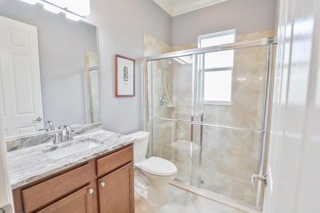 bathroom featuring a shower with door, vanity, tile patterned floors, and toilet